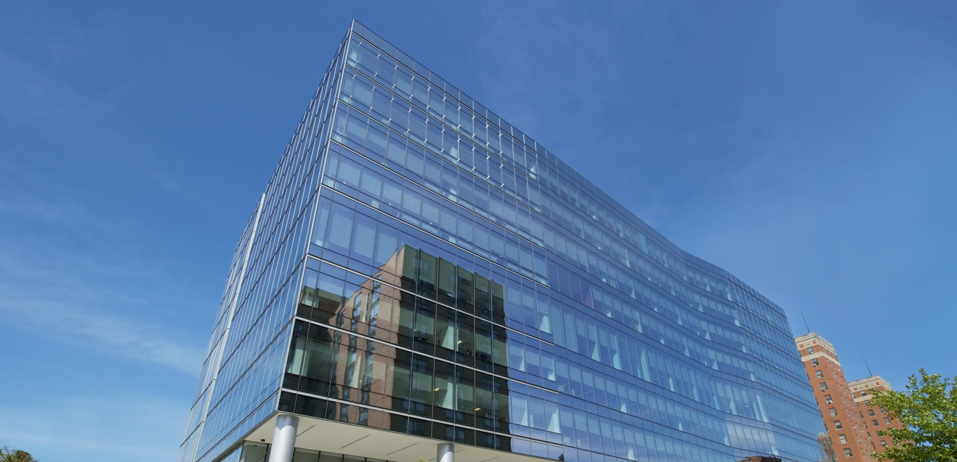 Cook County Central Campus Health Center, Chicago: a long glass façade against a blue sky