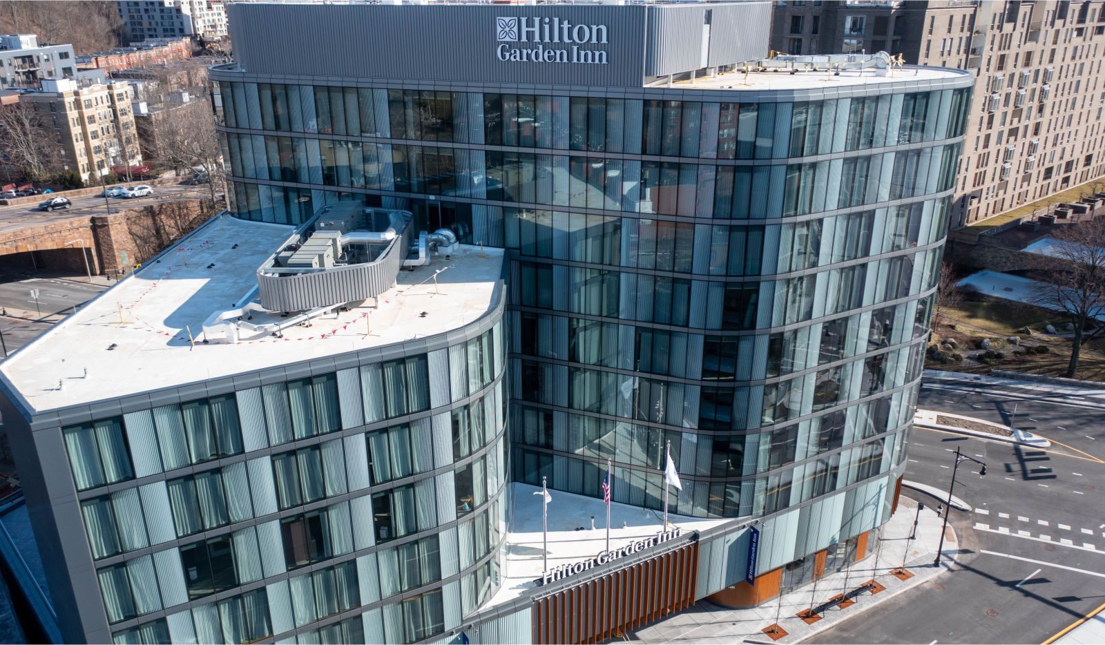 Hilton Garden Inn, Brookline: a curved glass hotel seen from above